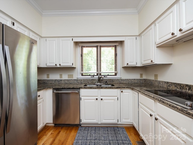 9413 Tillot Dr, Matthews, NC 28105 - kitchen with ornamental molding, appliances with stainless steel finishes, white cabinetry, light wood-style floors, and dark stone counters