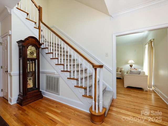 9413 Tillot Dr, Matthews, NC 28105 - stairs with wood finished floors, ornamental molding, and vaulted ceiling