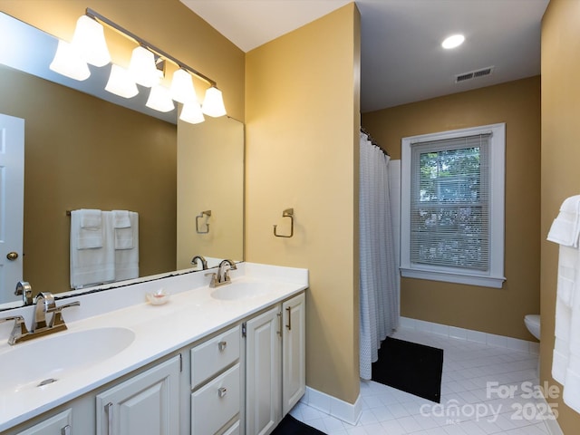 9413 Tillot Dr, Matthews, NC 28105 - bathroom with double vanity, tile patterned floors, and curtained shower