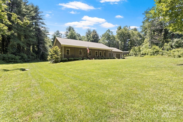 99 Pinecrest Estates Dr, Flat Rock, NC 28731 - view of green lawn with a garage