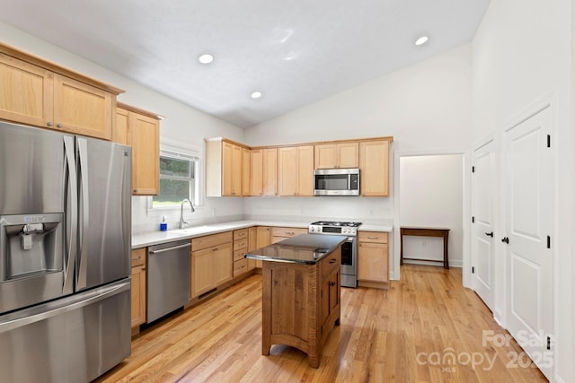 99 Pinecrest Estates Dr, Flat Rock, NC 28731 - kitchen with appliances with stainless steel finishes, light brown cabinets, light wood-style flooring, recessed lighting, and high vaulted ceiling