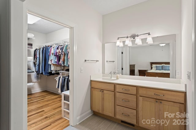 99 Pinecrest Estates Dr, Flat Rock, NC 28731 - full bath with vanity, a walk in closet, and wood finished floors