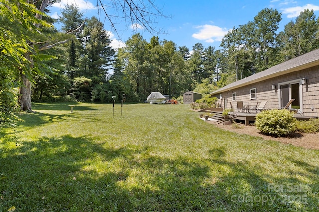 99 Pinecrest Estates Dr, Flat Rock, NC 28731 - view of grassy yard with a shed, a deck, and view of scattered trees