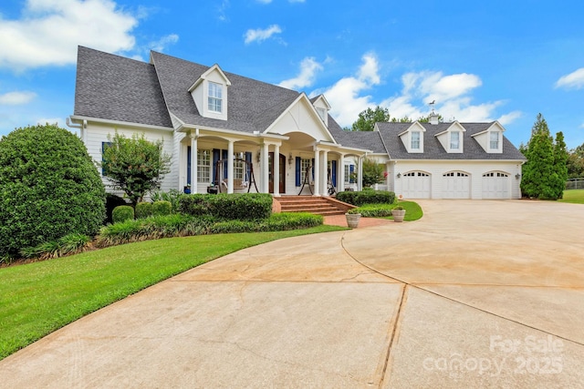 340 Harrison Rd, Roebuck, SC 29376 - cape cod-style house with concrete driveway, covered porch, a front yard, an attached garage, and a shingled roof