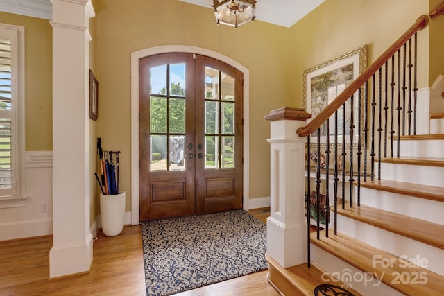 340 Harrison Rd, Roebuck, SC 29376 - foyer entrance featuring light wood-style floors, french doors, arched walkways, stairs, and wainscoting