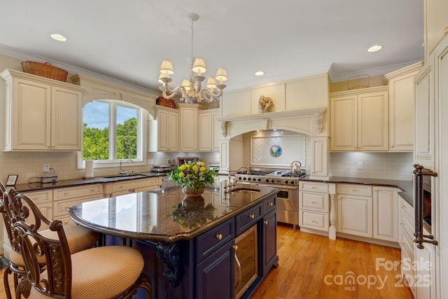 340 Harrison Rd, Roebuck, SC 29376 - kitchen featuring range with two ovens, blue cabinets, a chandelier, crown molding, and decorative backsplash