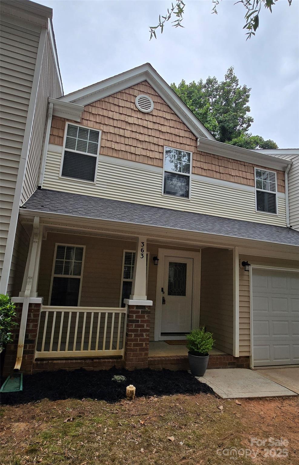 363 Doughton Ln Unit 153, Charlotte, NC 28217 - view of front facade with a porch and a garage