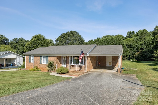 121 Kee Rd, Belmont, NC 28012 - ranch-style house with asphalt driveway, a front lawn, brick siding, and a carport
