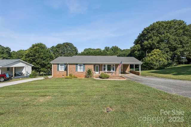 121 Kee Rd, Belmont, NC 28012 - ranch-style house with asphalt driveway, brick siding, covered porch, and a front yard