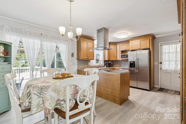 121 Kee Rd, Belmont, NC 28012 - kitchen featuring appliances with stainless steel finishes, crown molding, island exhaust hood, light wood-style floors, and backsplash