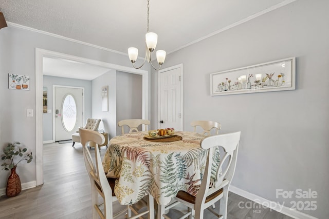 121 Kee Rd, Belmont, NC 28012 - dining space featuring crown molding, wood finished floors, and a chandelier