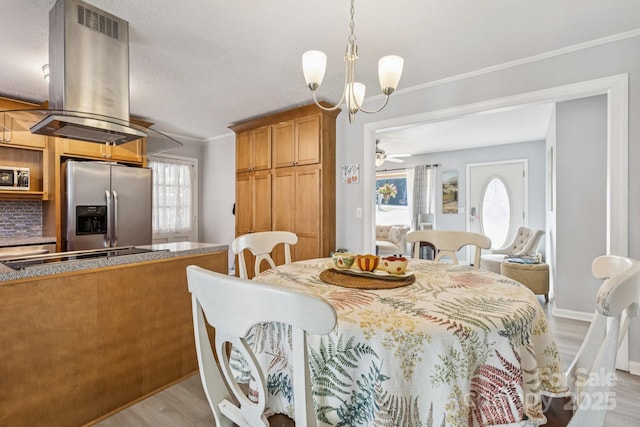 121 Kee Rd, Belmont, NC 28012 - dining room featuring light wood finished floors, a chandelier, ceiling fan, and ornamental molding