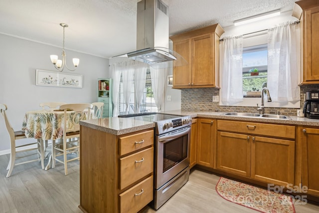 121 Kee Rd, Belmont, NC 28012 - kitchen with stainless steel range with electric cooktop, island exhaust hood, light wood-style flooring, backsplash, and brown cabinetry