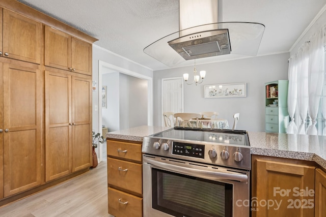 121 Kee Rd, Belmont, NC 28012 - kitchen with stainless steel electric range, light wood-type flooring, brown cabinets, light countertops, and a chandelier
