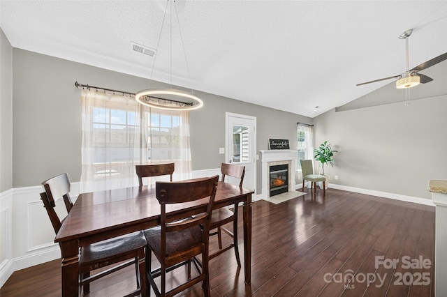 118 Milroy Ln Unit 171, Mooresville, NC 28115 - dining area featuring dark wood-style floors, vaulted ceiling, ceiling fan, and a fireplace