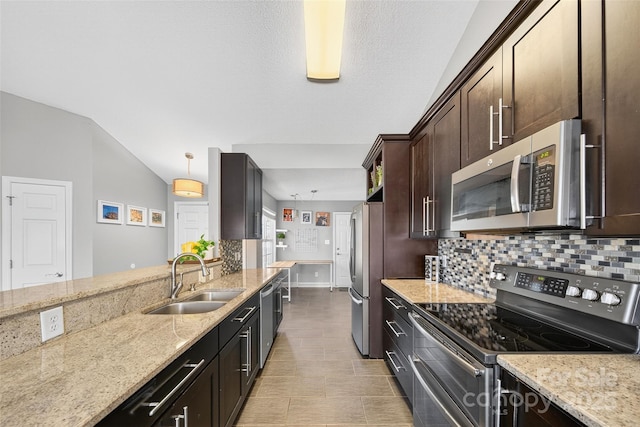 118 Milroy Ln Unit 171, Mooresville, NC 28115 - kitchen with stainless steel appliances, tasteful backsplash, dark brown cabinetry, light stone countertops, and hanging light fixtures