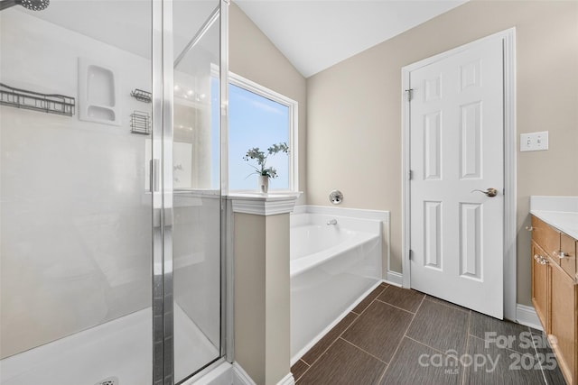 118 Milroy Ln Unit 171, Mooresville, NC 28115 - full bath with vanity, a shower stall, a garden tub, and vaulted ceiling