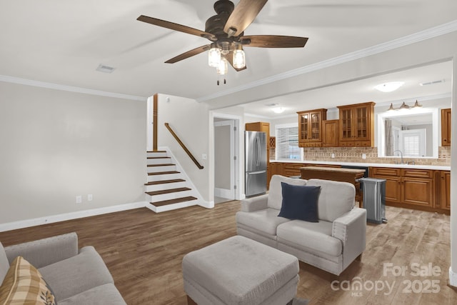 213 Turkey Hill Dr, King, NC 27021 - living area featuring ornamental molding, stairway, a ceiling fan, and light wood-style floors