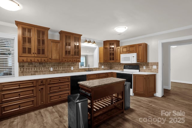 213 Turkey Hill Dr, King, NC 27021 - kitchen featuring electric stove, brown cabinetry, ornamental molding, backsplash, and light countertops