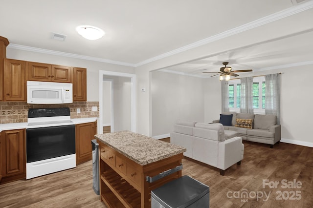 213 Turkey Hill Dr, King, NC 27021 - kitchen featuring white appliances, light countertops, wood finished floors, decorative backsplash, and brown cabinetry