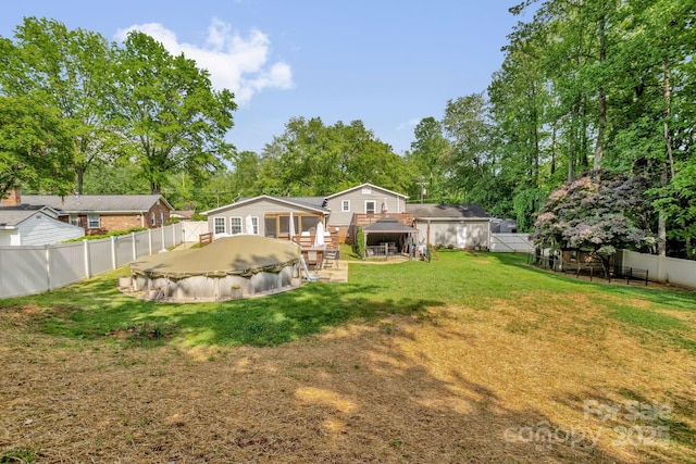 213 Turkey Hill Dr, King, NC 27021 - rear view of house with a fenced backyard, a gazebo, view of scattered trees, and a patio area