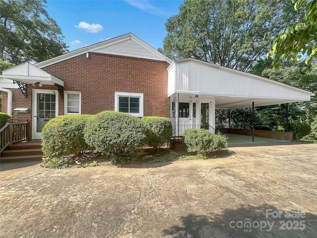 208 N Gaston St, Kings Mountain, NC 28086 - view of front of house with brick siding, driveway, and a carport