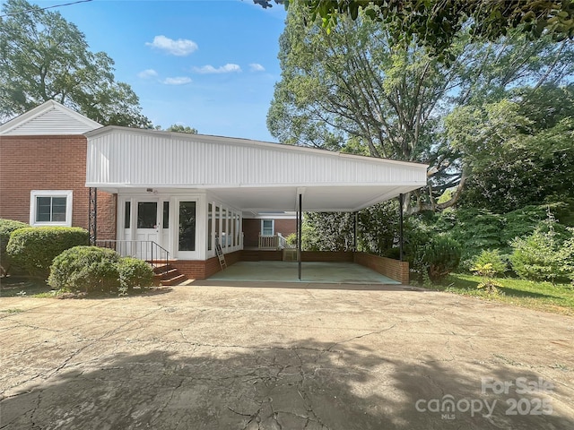 208 N Gaston St, Kings Mountain, NC 28086 - view of front of house with driveway, brick siding, and a carport