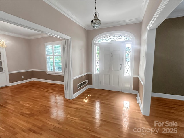 208 N Gaston St, Kings Mountain, NC 28086 - entrance foyer with a chandelier, light wood-type flooring, and crown molding