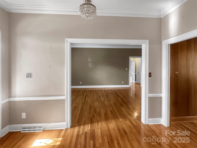 208 N Gaston St, Kings Mountain, NC 28086 - hall featuring wood finished floors, a chandelier, and crown molding