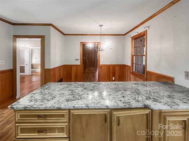 208 N Gaston St, Kings Mountain, NC 28086 - kitchen featuring a chandelier, a wainscoted wall, wood finished floors, wood walls, and light stone counters