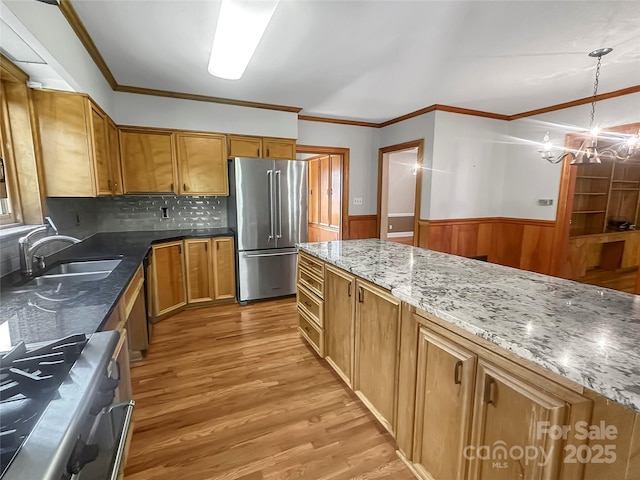 208 N Gaston St, Kings Mountain, NC 28086 - kitchen with high end fridge, light wood-style floors, a chandelier, range, and wainscoting