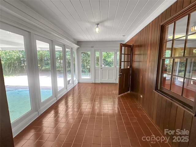 208 N Gaston St, Kings Mountain, NC 28086 - unfurnished sunroom with french doors, healthy amount of natural light, wooden walls, and tile patterned floors