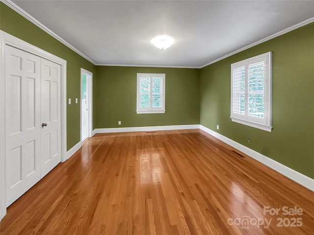208 N Gaston St, Kings Mountain, NC 28086 - unfurnished bedroom with crown molding, wood finished floors, and a closet
