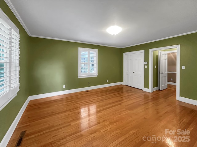 208 N Gaston St, Kings Mountain, NC 28086 - unfurnished bedroom with ornamental molding, wood finished floors, and a closet