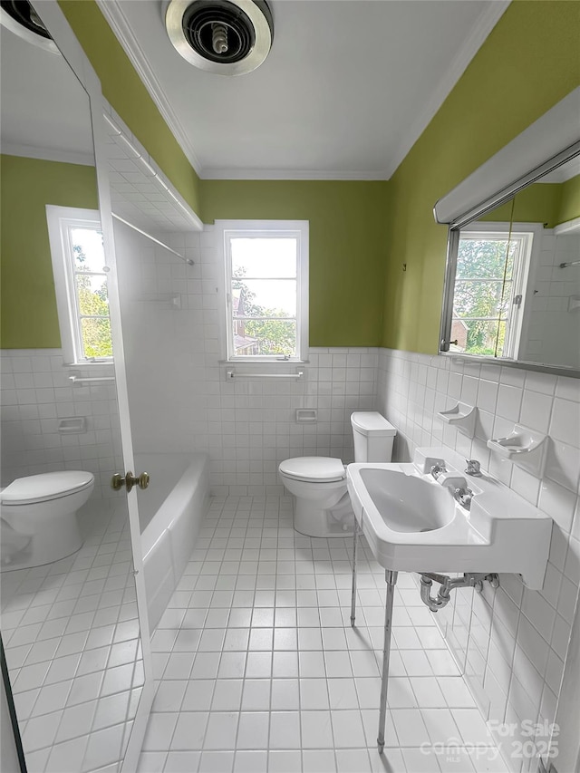 208 N Gaston St, Kings Mountain, NC 28086 - full bath with tile walls, tile patterned flooring, healthy amount of natural light, a wainscoted wall, and ornamental molding