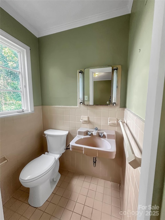 208 N Gaston St, Kings Mountain, NC 28086 - half bathroom featuring tile walls, tile patterned flooring, crown molding, and a wainscoted wall