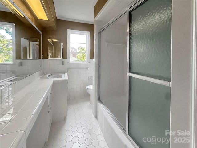 208 N Gaston St, Kings Mountain, NC 28086 - bathroom featuring tile patterned flooring, vanity, tile walls, and shower / bath combination with glass door