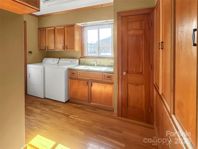 208 N Gaston St, Kings Mountain, NC 28086 - laundry area featuring cabinet space, washer and clothes dryer, crown molding, and light wood-type flooring