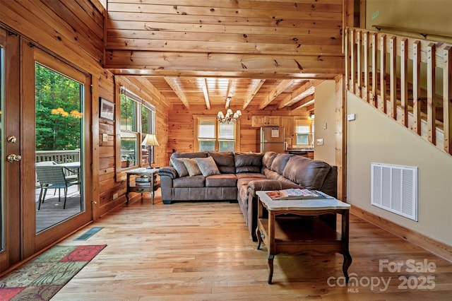 599 Shoal Creek Trl, Nebo, NC 28761 - living area with wooden walls, a chandelier, light wood-style floors, and a wood ceiling with exposed beams