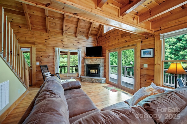 599 Shoal Creek Trl, Nebo, NC 28761 - living room with plenty of natural light, wood finished floors, wooden ceiling, wooden walls, and a fireplace
