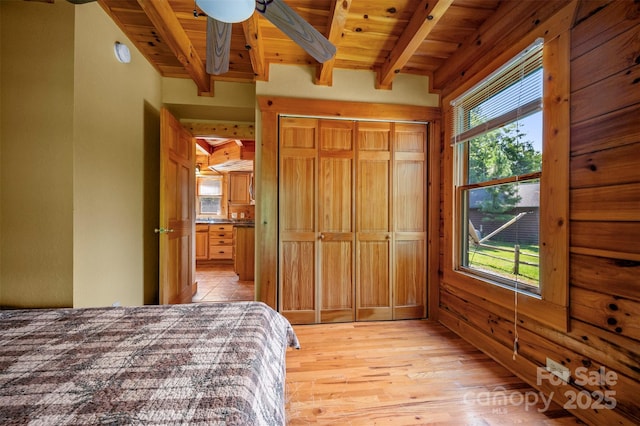 599 Shoal Creek Trl, Nebo, NC 28761 - bedroom with light wood finished floors, a wood ceiling with exposed beams, and ensuite bath