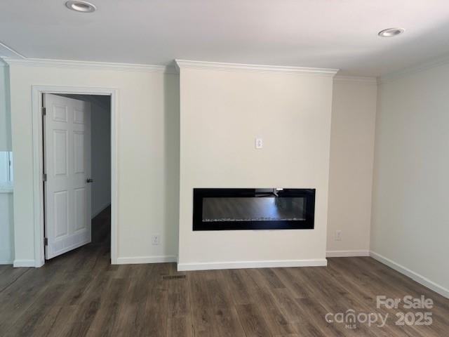 4163 Tallent Rd, Morganton, NC 28655 - unfurnished living room featuring a glass covered fireplace, ornamental molding, wood finished floors, and recessed lighting