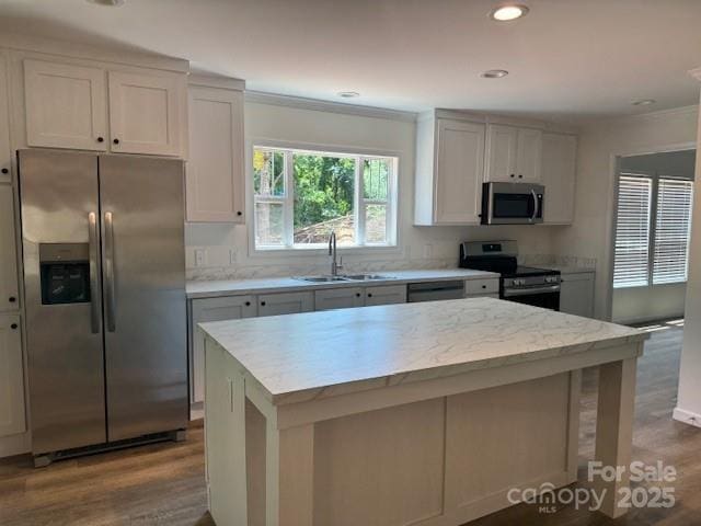 4163 Tallent Rd, Morganton, NC 28655 - kitchen with appliances with stainless steel finishes, dark wood finished floors, ornamental molding, a kitchen island, and recessed lighting