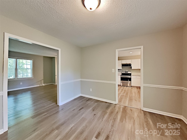 7420 Castlebar Rd, Charlotte, NC 28270 - empty room with light wood finished floors and a textured ceiling