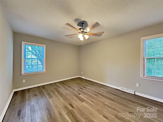 7420 Castlebar Rd, Charlotte, NC 28270 - unfurnished room with healthy amount of natural light, wood finished floors, a textured ceiling, and a ceiling fan