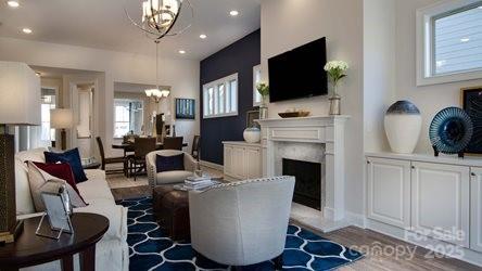8414 Profit Ln, Charlotte, NC 28215 - living area featuring a chandelier, a fireplace, and recessed lighting