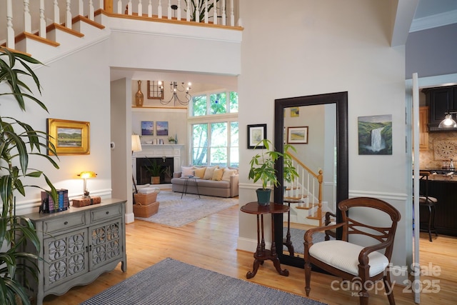 25 Madelyn Ln, Fairview, NC 28730 - corridor featuring a towering ceiling, stairs, light wood-style flooring, and a chandelier
