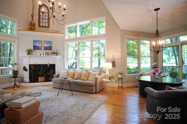 25 Madelyn Ln, Fairview, NC 28730 - living room with a chandelier, plenty of natural light, a high ceiling, and light wood-style flooring