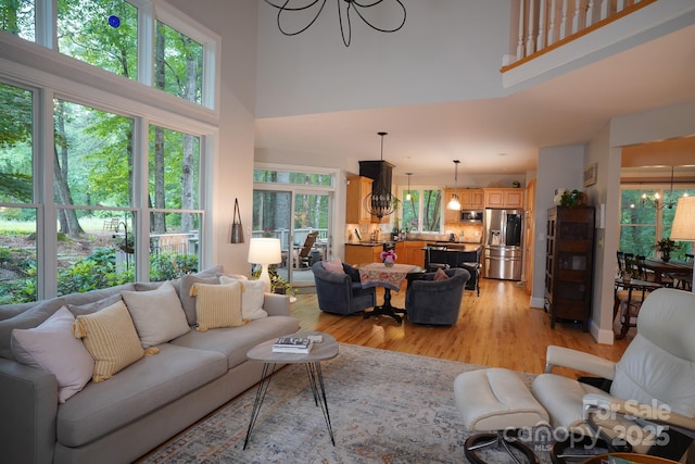 25 Madelyn Ln, Fairview, NC 28730 - living room with a chandelier, a towering ceiling, and light wood finished floors