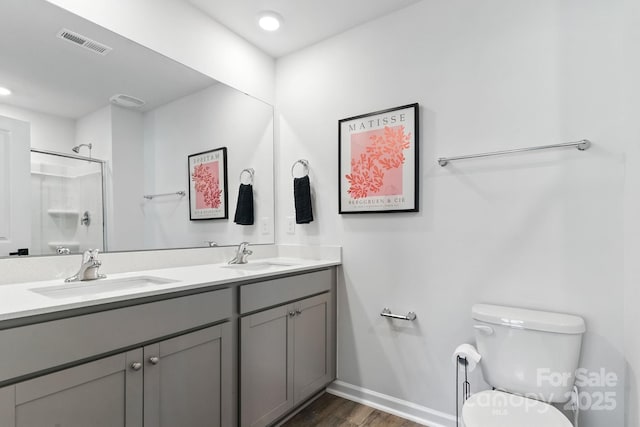130 St James Way, Sanford, NC 27332 - bathroom with double vanity, wood finished floors, a shower, and recessed lighting